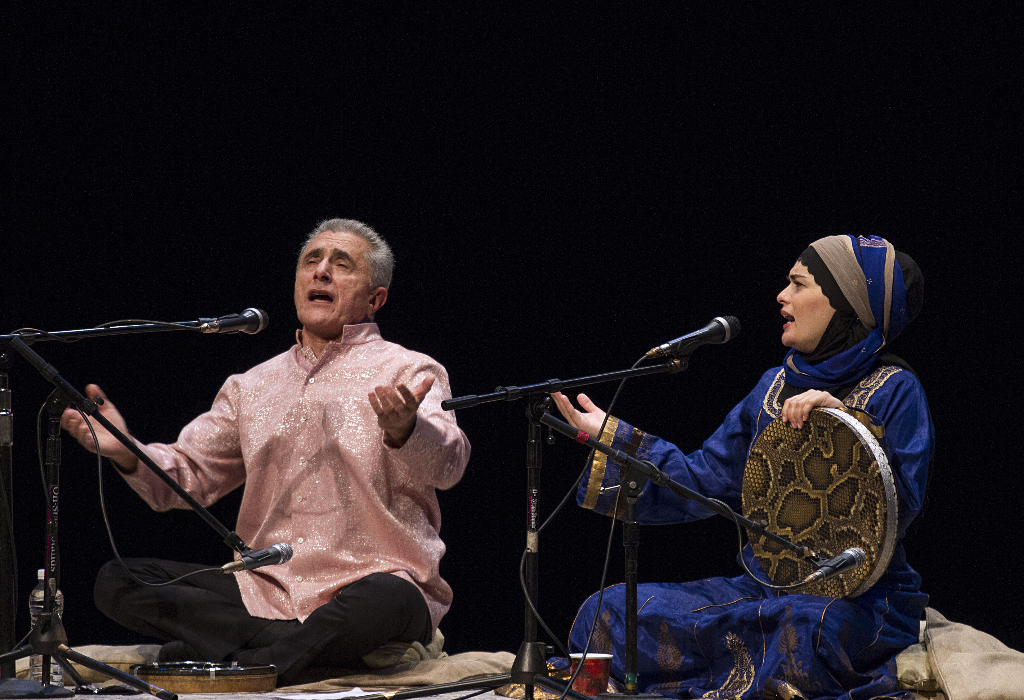Alim Qasimov and Fargana Qasimova singing seated beside one another, with a decorated frame drum in Fargana's lap.